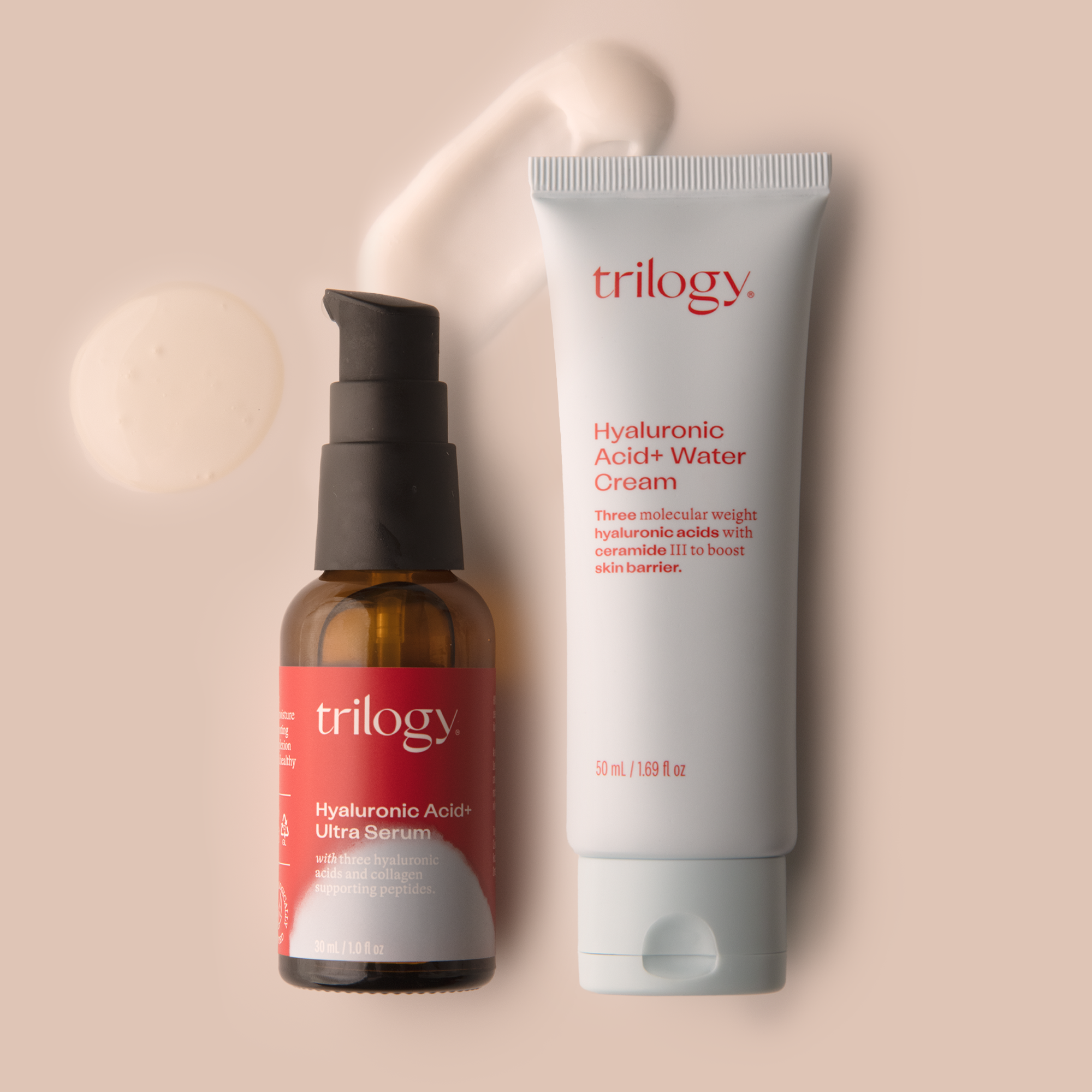 Two skincare products from Trilogy, a hyaluronic acid serum in a red dropper bottle and a water cream in a white tube with blue text, both against a neutral background.